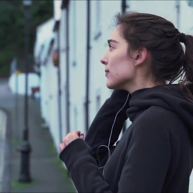 Profile at a window in a dark hoodie, Edinburgh